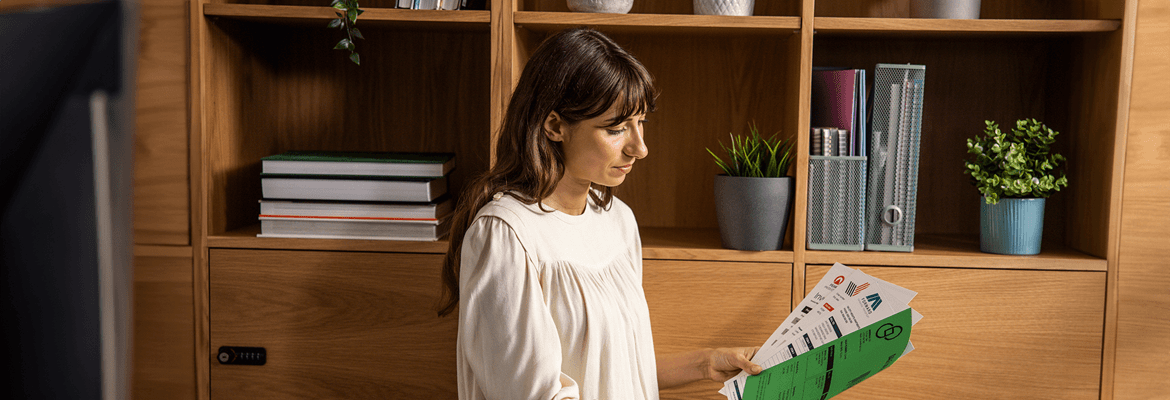 a woman holding paper to represent sustainability